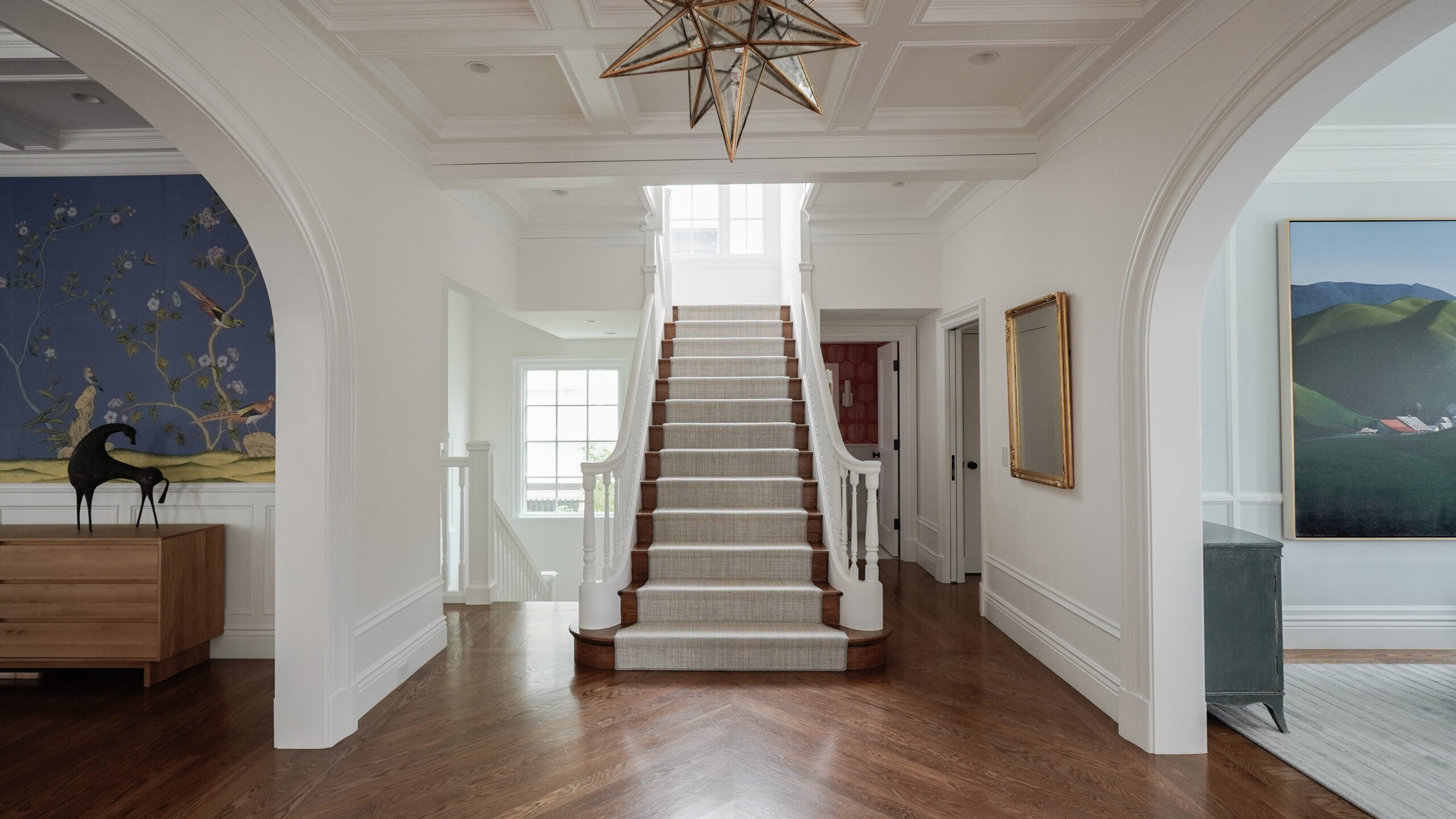 Large bright foyer with central staircase.
